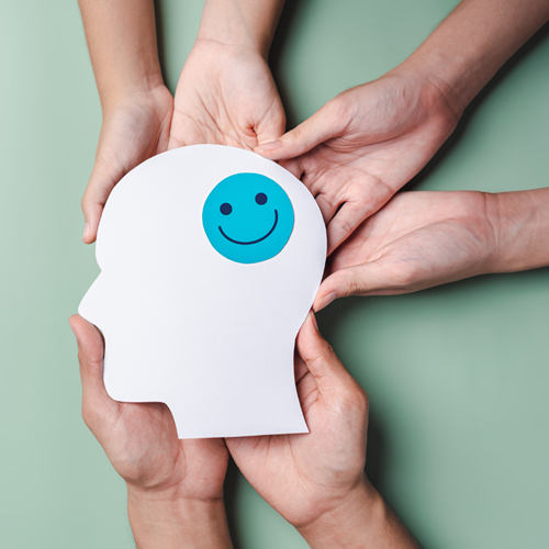 Hands holding a happy brain - decorative