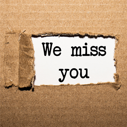 The text We miss you as if unwrapped from a package